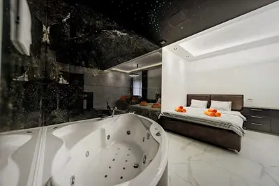 a bathroom with a bath tub and a bed at Dark Nest 3 Belgrade Apartments in Zvezdara