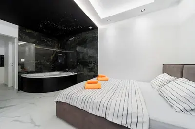a bedroom with a bed and a bath tub at Dark Nest 3 Belgrade Apartments in Zvezdara