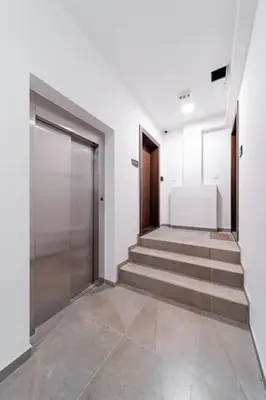 a hallway with a door and stairs in a building at Dark Nest 3 Belgrade Apartments in Zvezdara