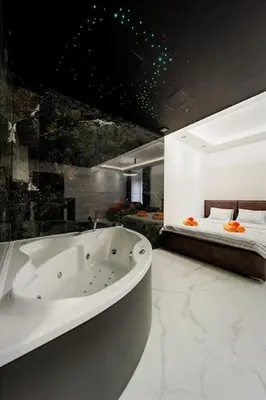 a bathroom with a bath tub and a bed at Dark Nest 3 Belgrade Apartments in Zvezdara