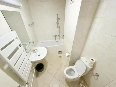 a white bathroom with a toilet and a sink at Apartment B5 in Belgrade
