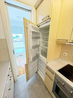 a kitchen with an empty refrigerator and a window at Apartment B5 in Belgrade