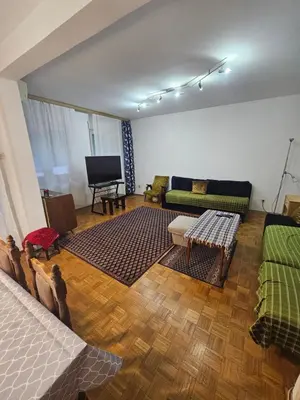 a living room with a couch and a television at Stan na karaburmi in Rospi Ćuprija