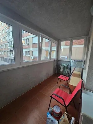 an empty room with three chairs and windows at Stan na karaburmi in Rospi Ćuprija