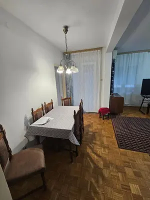 a dining room with a white table and chairs at Stan na karaburmi in Rospi Ćuprija