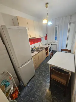 a kitchen with a refrigerator and a table in it at Stan na karaburmi in Rospi Ćuprija