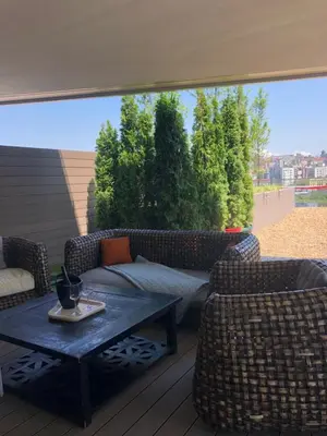 a patio with a couch and two chairs and a table at Exquisite BW Residences 210sqm condo in Sajmište