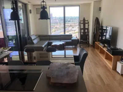 a living room with a couch and a table at Exquisite BW Residences 210sqm condo in Sajmište