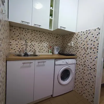 a kitchen with a washing machine and a sink at Fontana cozy apartment near Danube river in Belgrade