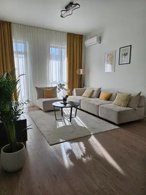 a living room with a couch and a table at ALPHA LUX - Galerija mall view - Beograd na vodi in Belgrade