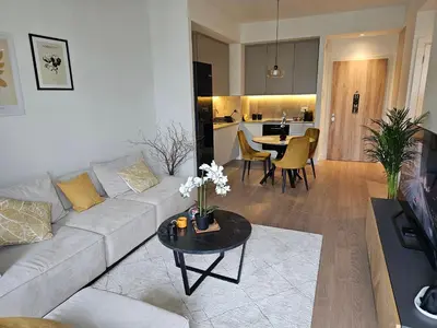 a living room with a couch and a table at ALPHA LUX - Galerija mall view - Beograd na vodi in Belgrade