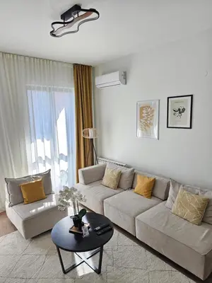 a living room with a couch and a table at ALPHA LUX - Galerija mall view - Beograd na vodi in Belgrade