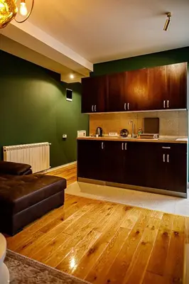 a living room with a couch and a kitchen at Apartment A2, Center, Belgrade in Belgrade