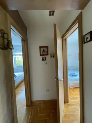 a hallway with a door leading to a bedroom at Comfy & Cozy Apartment - parking in Karaburma