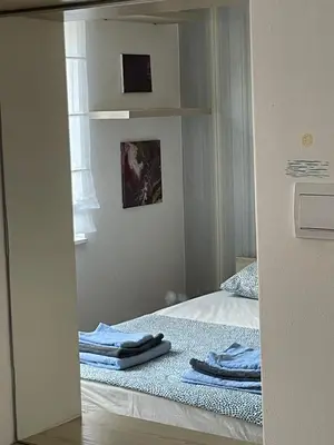a small bedroom with a bed with towels on it at Comfy & Cozy Apartment - parking in Karaburma