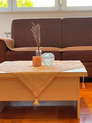 a coffee table in front of a couch at Comfy & Cozy Apartment - parking in Karaburma