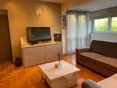 a living room with a couch and a tv at Comfy & Cozy Apartment - parking in Karaburma