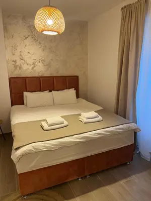 a bedroom with a bed with two towels on it at Anna apartment in Belgrade