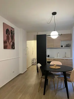 a living room with a black table and chairs at Anna apartment in Belgrade