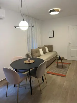 a living room with a table and a couch at Anna apartment in Belgrade