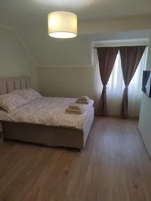 a bedroom with a bed and a large window at Apartman Anđela in Jakovo