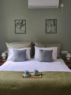 a bed with two cups and a tray on it at Fera in Belgrade