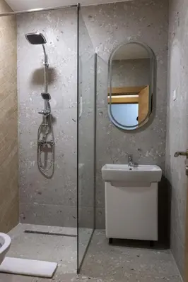 a bathroom with a shower and a sink and a mirror at Fera in Belgrade