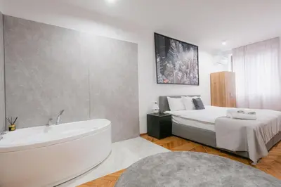 a bathroom with a bed and a bathtub and a bath tub at Fera in Belgrade