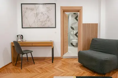 a living room with a desk and a chair at Fera in Belgrade