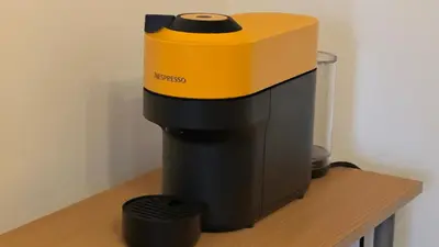 a yellow and black coffee maker on a wooden counter at Arena BGD - Hadrianz Apartment in Novi Beograd