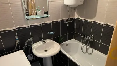a bathroom with a sink and a toilet and a tub at Arena BGD - Hadrianz Apartment in Novi Beograd