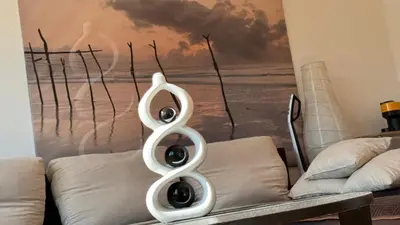 a white sculpture sitting on top of a couch at Arena BGD - Hadrianz Apartment in Novi Beograd