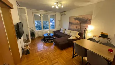 a living room with a couch and a table at Arena BGD - Hadrianz Apartment in Novi Beograd