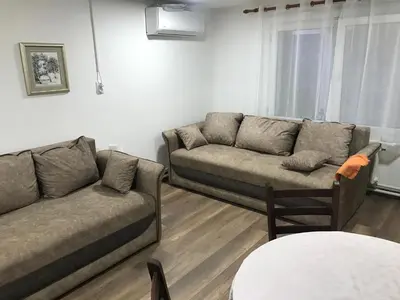 a living room with two couches and a table at Near Highway free parking apartment in Rakovica