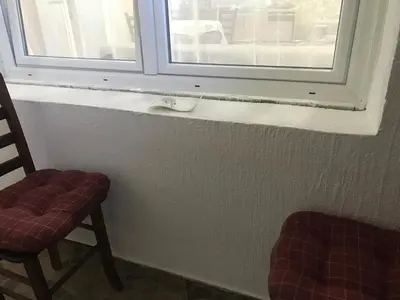 a window in a room with two chairs and a window at Near Highway free parking apartment in Rakovica