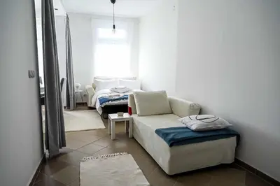 a living room with a couch and a window at Paun Apartmani in Smederevo