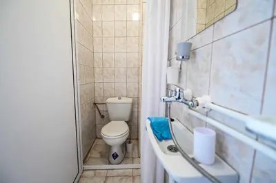 a small bathroom with a toilet and a sink at Paun Apartmani in Smederevo