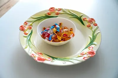 a bowl of candy on a plate on a table at Paun Apartmani in Smederevo