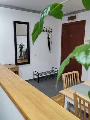 a dining room with a table and a mirror at Apartman Ingrid in Belgrade