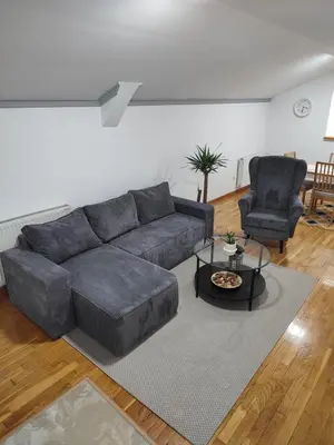 a living room with a couch and two chairs at Apartman Ingrid in Belgrade