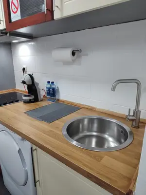 a kitchen counter with a stainless steel sink at Apartman Ingrid in Belgrade