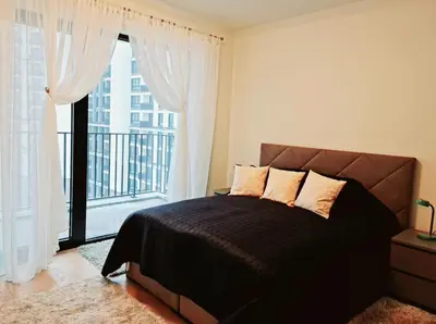 a bedroom with a bed and a large window at Delux Simfonija Belgrade Waterfront in Sajmište