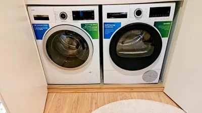 two washing machines in a laundry room with a rug at Delux Simfonija Belgrade Waterfront in Sajmište