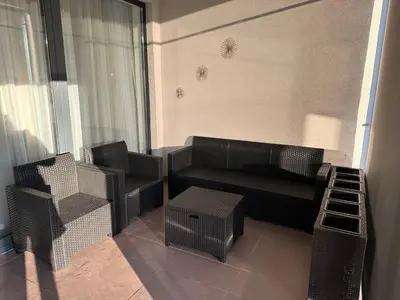 a small living room with a couch and chairs at Apartman Kosmajska Vila in Rogača