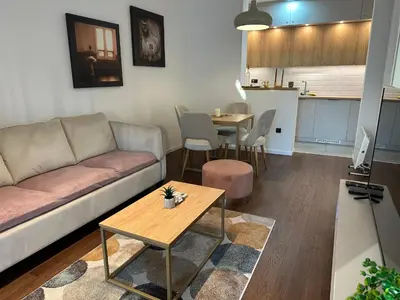 a living room with a couch and a table at Apartman Kosmajska Vila in Rogača