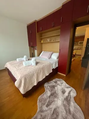 a bedroom with two beds and a rug at Akacija - Belvil in Belgrade
