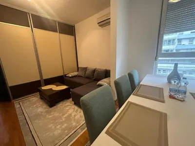 a small living room with a table and a couch at Akacija - Belvil in Belgrade