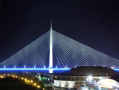a large white bridge at night with a city at Akacija - Belvil in Belgrade
