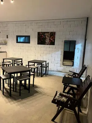 a room with tables and chairs in front of a brick wall at Lokal za zurke, slavlja i rodjendane in Pećinci