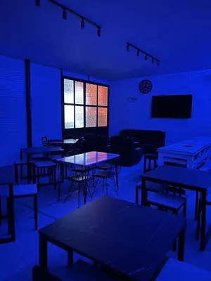 an empty room with tables and chairs and a tv at Lokal za zurke, slavlja i rodjendane in Pećinci